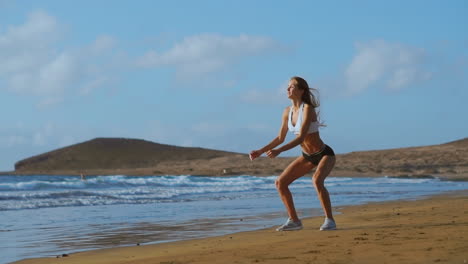Sportswoman-Wearing-Sportswear-Doing-Squats-Exercise-Outdoors.-Fitness-Female-Working-Out-on-the-Beach-at-Sunset.-Athletic-Young-Woman-is-Engaged-in-Outdoor-Sports.